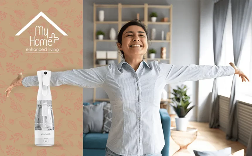 Lively Indian woman with a wide smile and MyHomePlus disinfectant spray in the frame