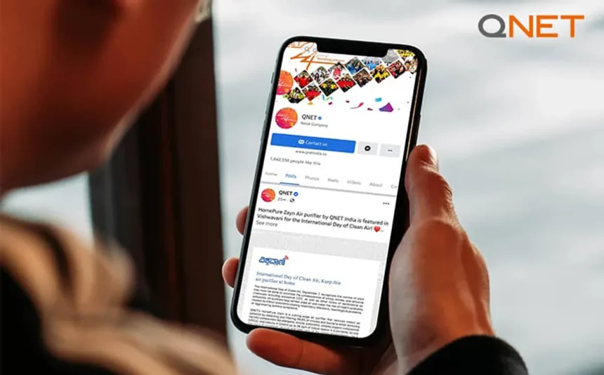 A young man going through QNET social media toolkit on his mobile