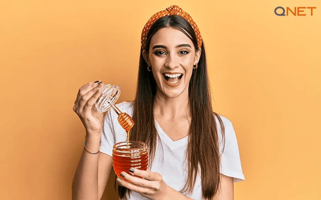 A young woman relishing NMR tested Nutriplus Monofloral Honey