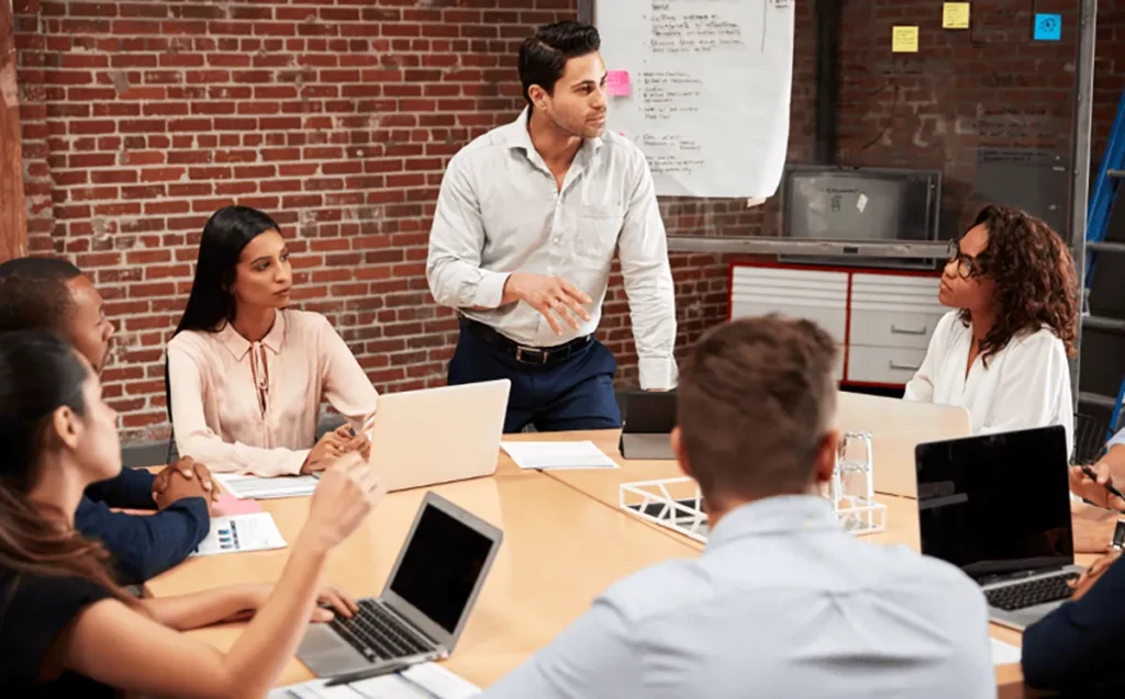 A QNET distributor explaining the QNET business model to prospects to earn step commissions
