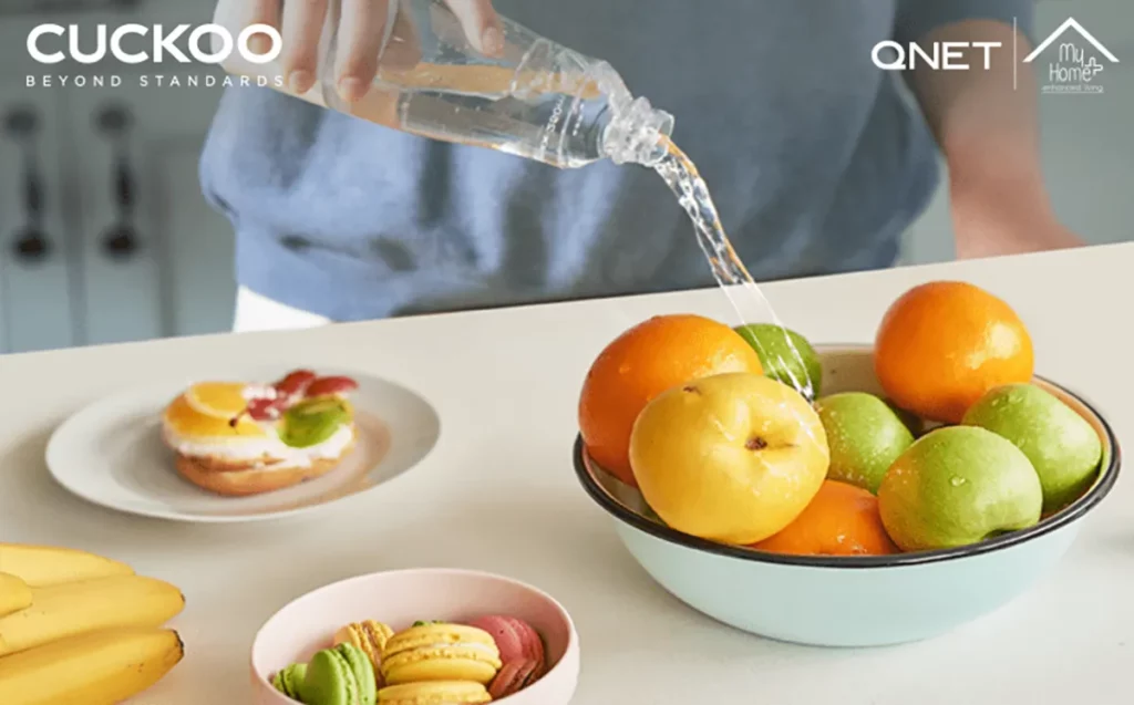 A man sterilising fruits and vegetables with MyHomePlus DSG in a well-maintained kitchen