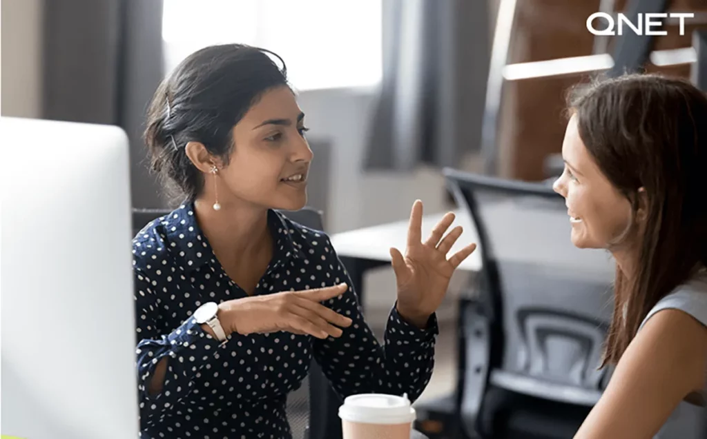 A young Indian woman honing her interpersonal skills by communicating with another woman as a direct seller