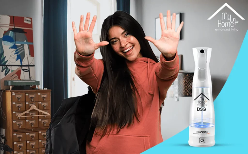 A young woman sitting in her home showing her hands with MyHomePlus DSG in the frame