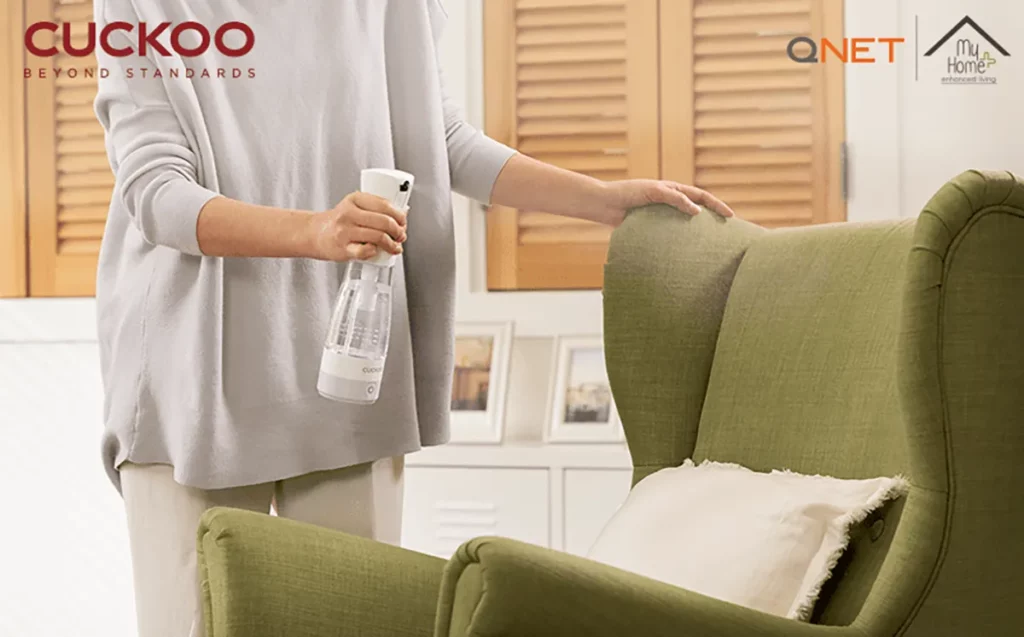 A young woman using MyHomePlus DSG in her living room for 99.99% sterilisation and deodorisation