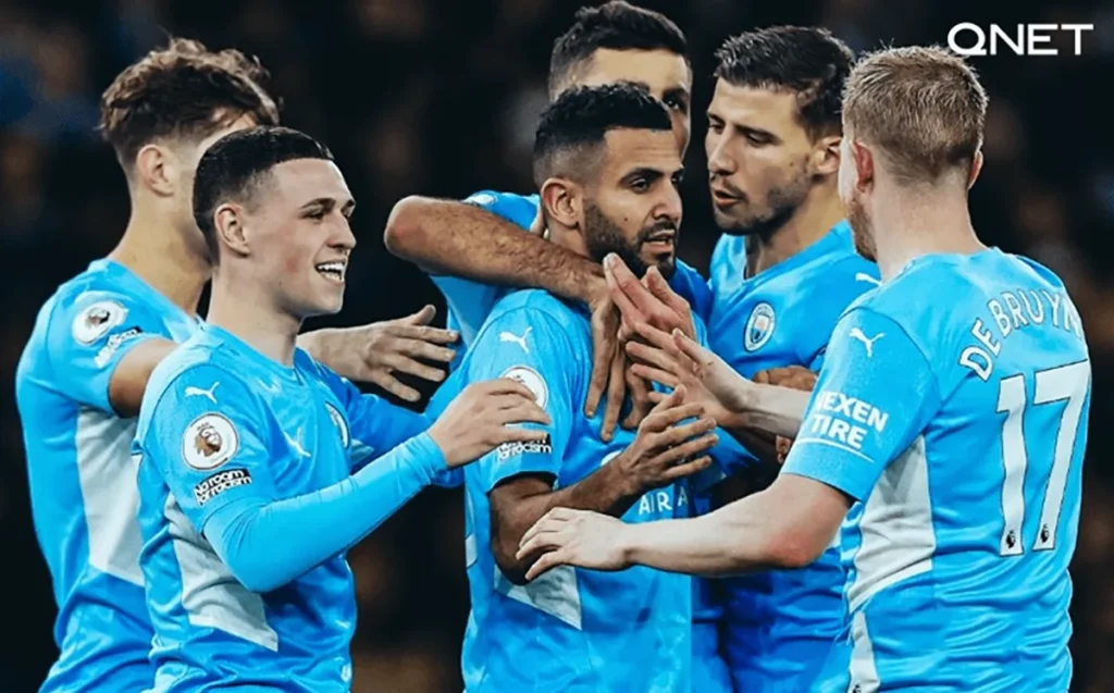Manchester City players celebrating a goal against Leeds United