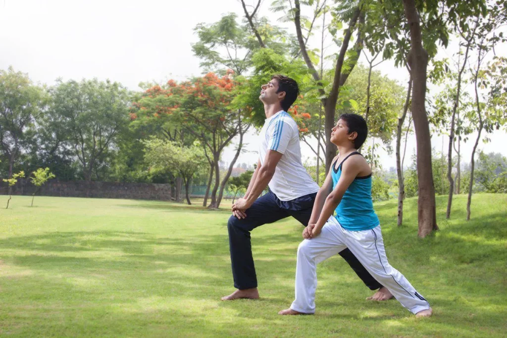 Father's Day: Father and son exercising in the park