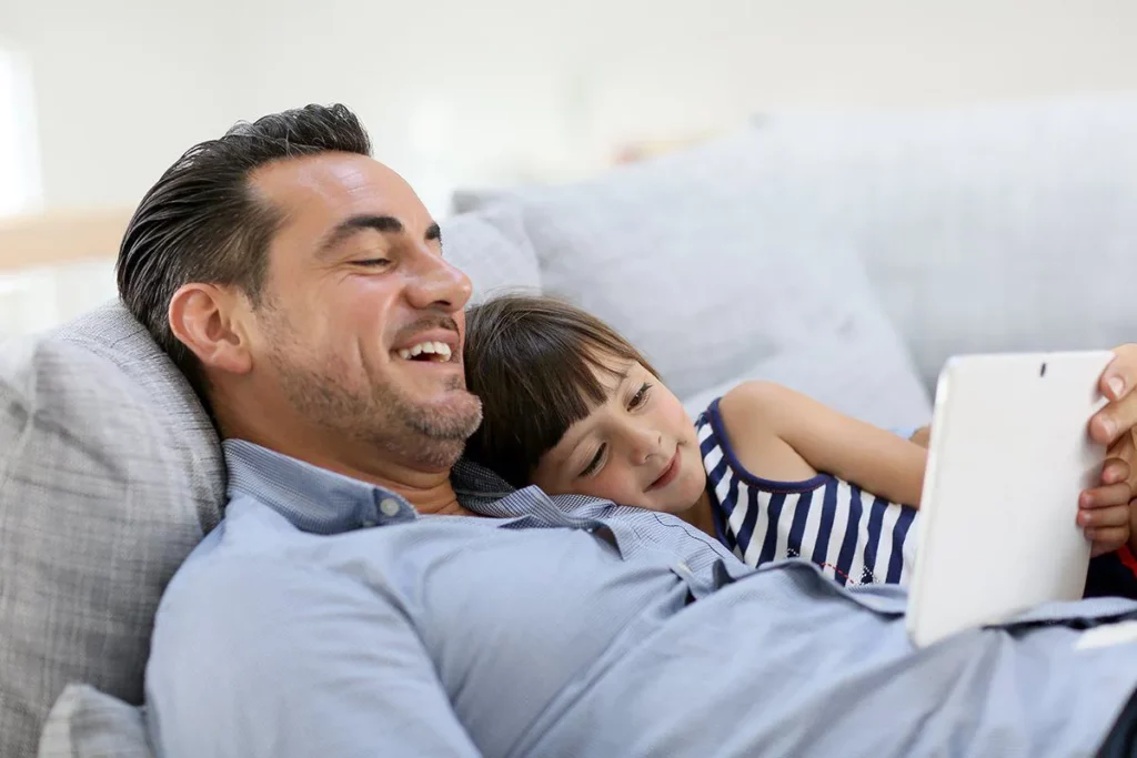 Father's Day: Father reading out story to daughter